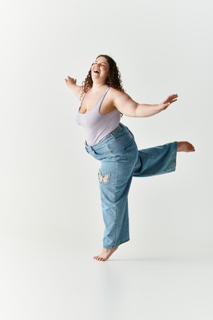 A young woman dances joyfully in a trendy outfit, radiating vibrancy in a bright space.