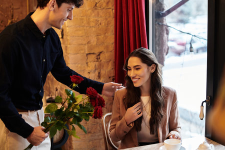 A happy couple shares a joyful moment amid roses, celebrating their love on Valentines Day.の写真素材