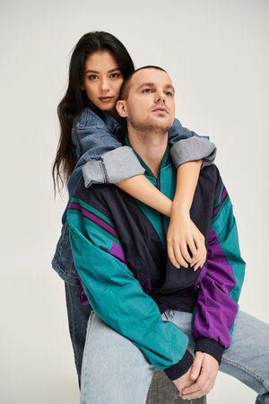 A stylish young couple shares their love in a cozy studio, celebrating romance.の写真素材