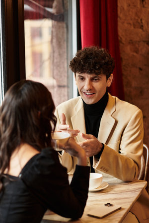 Celebrating love, a young couple shares a joyful moment, enjoying each others company while dining.の写真素材