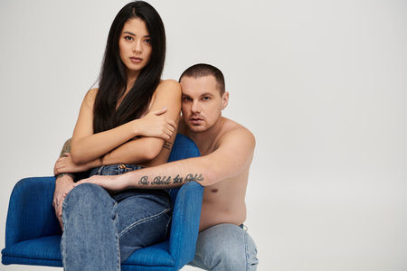 Couple shares an intimate moment in a studio, expressing love and desireの写真素材