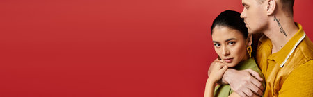 A beautiful couple embraces each other in stylish outfits, radiating romance and joy, bannerの写真素材