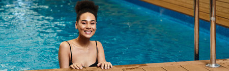 A young African American woman enjoys a moment of relaxation in a serene spa environment.の写真素材