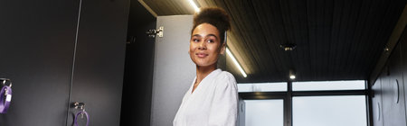 A young African American woman experiences tranquility in a spa environment, feeling refreshed.の写真素材