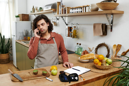 Young man manages his diabetes while preparing healthy meals at home in a stylish space.