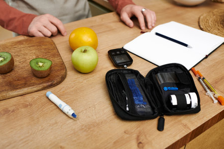 A young man explores his daily routine at home while managing diabetes health.の写真素材