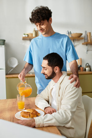 Two men enjoy a casual breakfast in their stylish apartment, sharing a moment of love.の写真素材