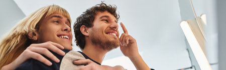 Two men share a joyful moment in a warm, lively atmosphere.