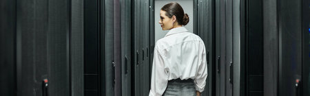 Woman in a white shirt works diligently in the IT department, maintaining server hardware, banner