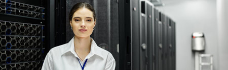 A woman in a white shirt manages server hardware in a high-tech data center, banner