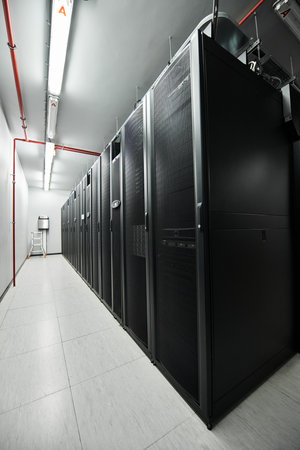 A professional data center features rows of server hardware in a sleek, modern setup.の写真素材