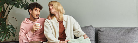 Two men share a warm and affectionate moment together while seated in a stylish living space.の写真素材