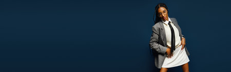 A young woman exudes confidence in a trendy outfit, showcasing her unique style with flairの写真素材