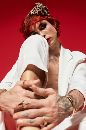 A young man with red hair expresses his individuality through unique fashion poses.