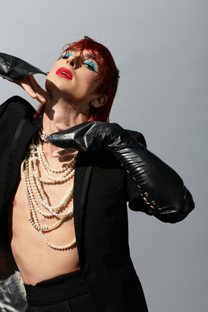 A young man with striking style poses confidently, highlighting vibrant fashion and artistic flair.の写真素材