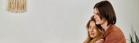 A chic young couple enjoys a warm moment together in their tastefully decorated living space.の写真素材