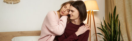 A young couple shares an intimate embrace in a softly lit bedroom, radiating warmth and affection.