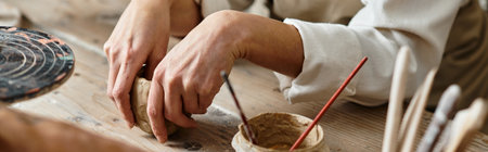 Mature woman enjoying her quality time while shaping clay in a pottery class, banner