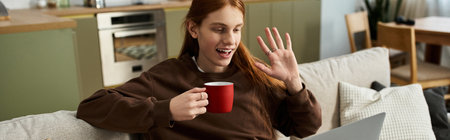 A charming young man with long red hair enjoys a warm beverage while smiling and waving, banner
