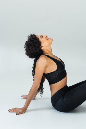 A confident fitness enthusiast showcases her toned physique in stylish workout gear.の写真素材