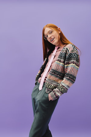 A young man with long red hair showcases his stylish outfit, exuding confidence and charm.のeditorial素材