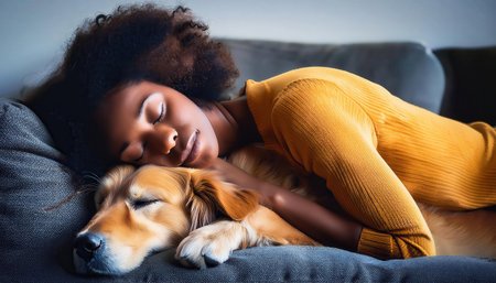 A person enjoys a peaceful nap with their beloved dog resting close, creating a warm atmosphere.の素材