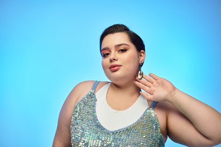 A young and pretty plus size woman poses gracefully, showcasing her style against a bright backdrop.のeditorial素材