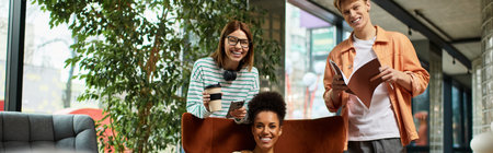 Three colleagues share a joyful moment at a cozy hotel lounge while engaging in a business trip.