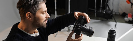 Focused individual skillfully adjusts camera settings in a contemporary photography studio.