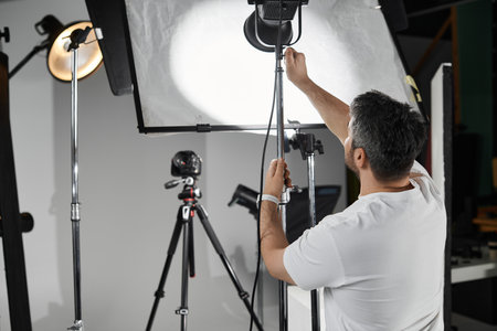 A skilled individual fine tunes the lighting equipment, preparing for a captivating session.のeditorial素材