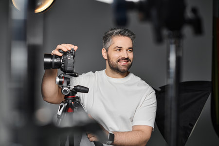 Skilled individual showcases camera gear in a well lit studio.