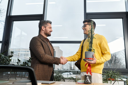 New hire shakes hands with manager, showcasing enthusiasm during onboarding in a bright office.
