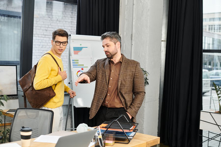 New employee receives guidance and tips from a mentor in a bright, contemporary office space.