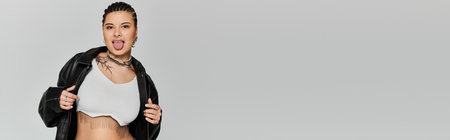 A young woman showcases her unique style in a trendy outfit, exuding confidence and attitude.のeditorial素材