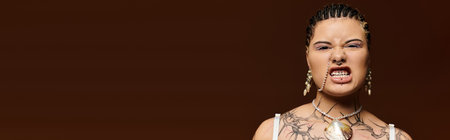 Young woman with intricate braids and striking jewelry radiates style and attitude.のeditorial素材