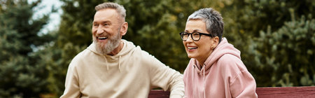 Two happy seniors share a moment of joy, embracing love and companionship in nature.の写真素材