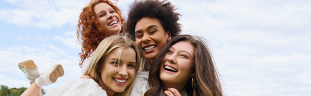 A group of stylish women embrace joy and confidence while enjoying a sunny day in nature.の写真素材