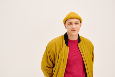 Handsome young man exudes confidence while modeling the latest fashion in a bright studio.のeditorial素材