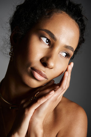 A graceful African American woman exudes elegance with stunning jewelry and style.の写真素材