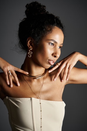 An elegant African American woman displays her fashion sense and stunning jewelry.の写真素材