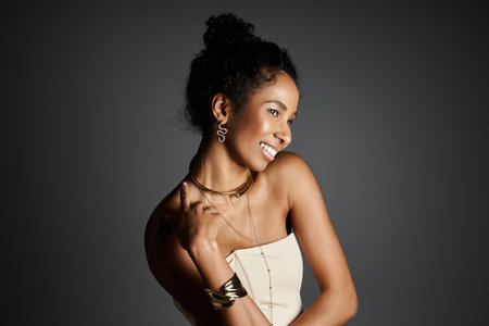 A confident African American woman showcases elegant jewelry and stylish attire.の写真素材