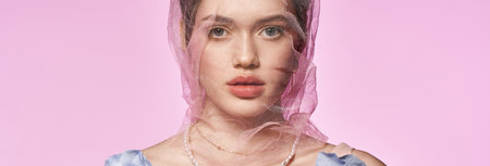 A beautiful young woman showcases her stylish spring look with a delicate scarf, radiating elegance.の写真素材