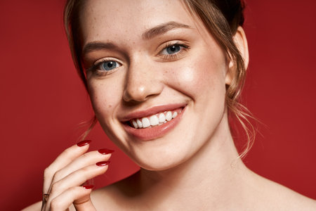 A young woman beams with style and trendy nails against a striking backdrop.の写真素材
