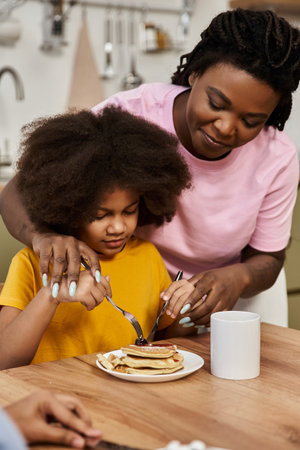 A lgbt family shares joyful moments while preparing breakfast together, showcasing love and unity.の写真素材