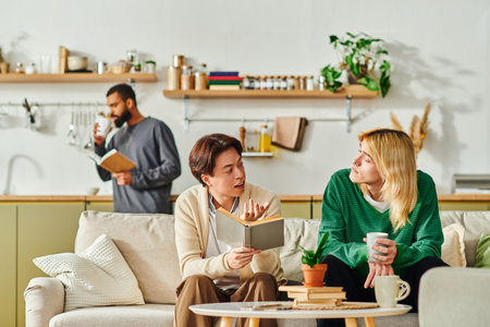 Three individuals connect over books in a cozy, modern living space.の写真素材