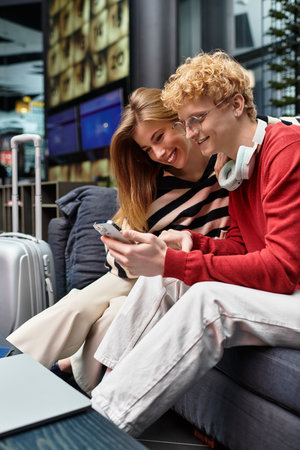 A young couple enjoying each others company at a modern hotel, sharing laughs and sweet moments.の写真素材