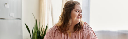 Smiling young woman with Down syndrome radiates joy and confidence in her cozy home.の写真素材