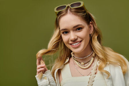 Young woman smiles with long hair, playfully styling her bright spring outfit.