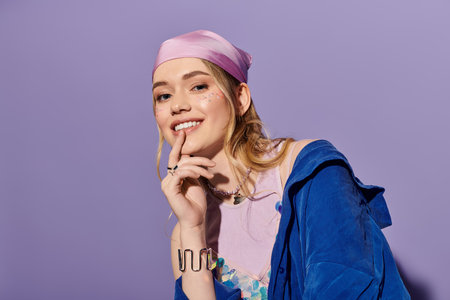 Stylish woman poses playfully in trendy attire, radiating joy in a bright, colorful spaceの写真素材