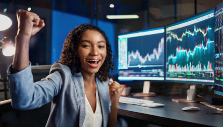 A female trader joyfully celebrates recent crypto profits while tracking market trends.の素材